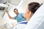 Male Nurse Adjusting Xray Machine For Patient